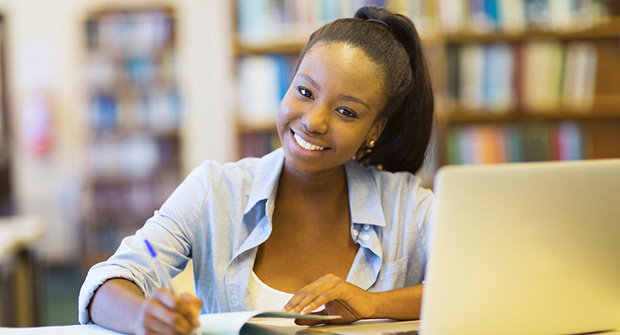 girl in library doing work