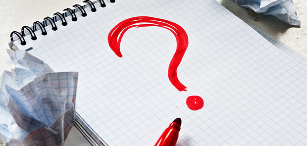 A red question mark on graph paper