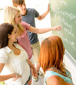 students doing math on a chalkboard