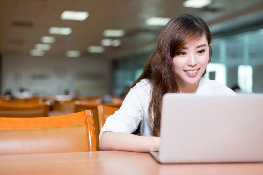 girl on laptop in library