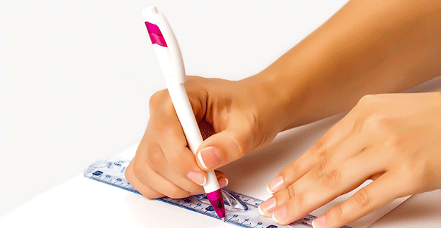 a girl using a pen and ruler to draw a line