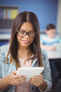 a girl with glasses on a tablet