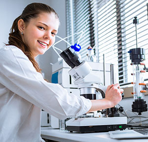 Girl looking through microscope