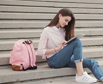 student looking at mobile device