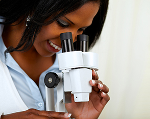 Girl studying in a microscope