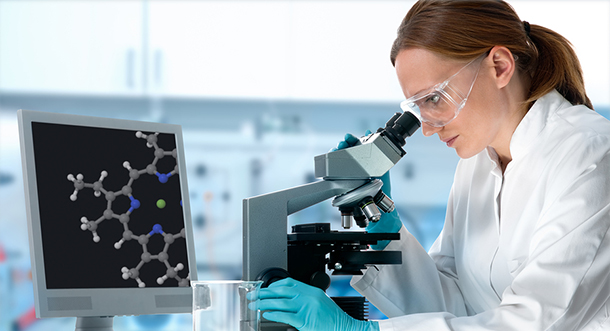 woman looking at microscope