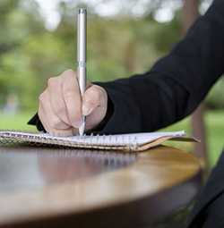 person writing with pen