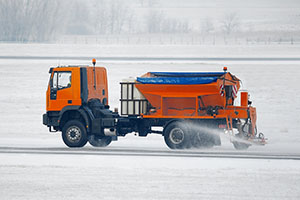 A truck de-ices a road