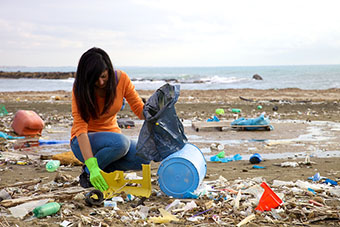 Woman picking up trash