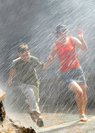 Girl and boy caught in the rain