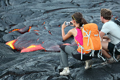 Two people looking at lava and using a mobile device