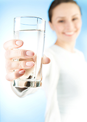 A girl holding a glass of water