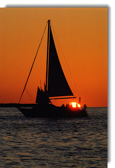 Image of boat sailing at sunset