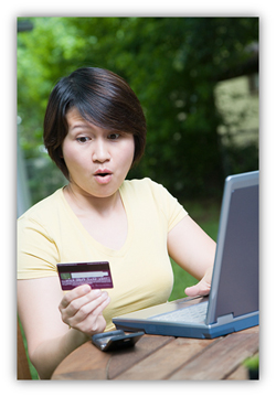 Image of woman holding credit card and looking worried.