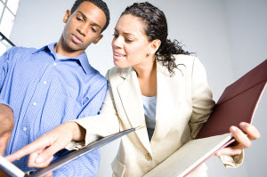 Two students looking at folders