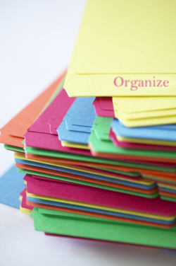 A stack of folders with the word organize on the top folder