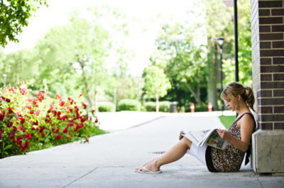 Girl reading newspaper