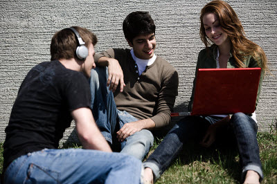 Students on headphones and computer