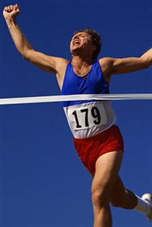 male athlete crossing finish line