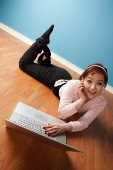 Girl on computer and phone