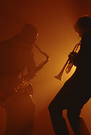 silhouettes of men playing instruments