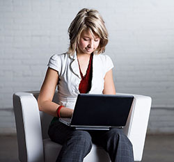 female student working on a laptop