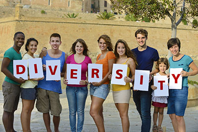 people holding letter signs reading "diversity"