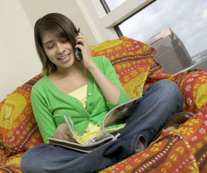 girl talking on phone and reading a magazine