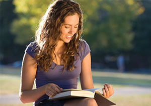 student reading a book on her lap