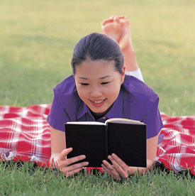 female student reading book