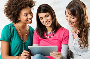 three students using a tablet