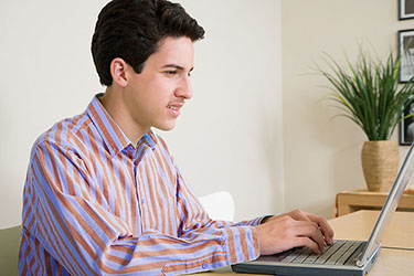 male student working on a computer