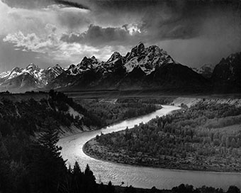 photograph of river, woods, and mountains