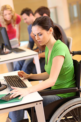 female student in wheel chair working on computer