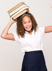 female student balancing books on her head