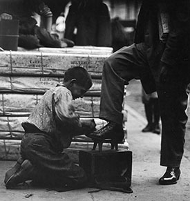 young boy shining shoes