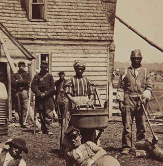 escaped slaves posing in front of a house