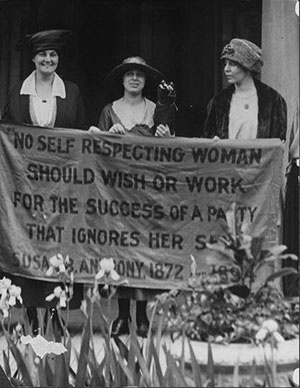 women holding a banner during suffrage parade