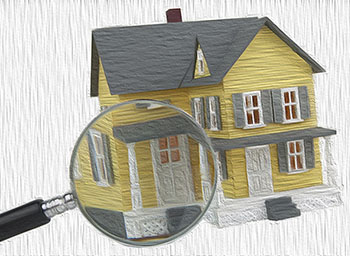 magnifying glass examining an American house