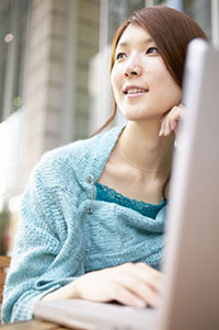 girl thinking at computer