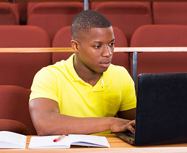 student researching on a laptop