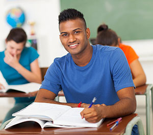 student working on an outline in class