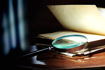 magnifying glass on an opened book