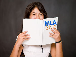 Girl holding MLA Style Guide