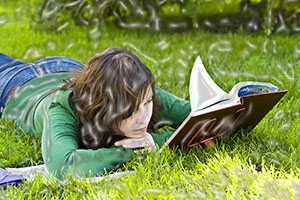 student reading in the grass