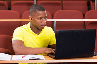 student working on a lap top