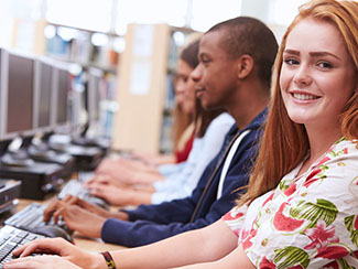 students writing on computers