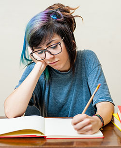 girl writing at a desk