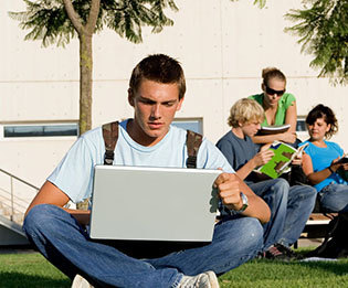 student typing on a laptop