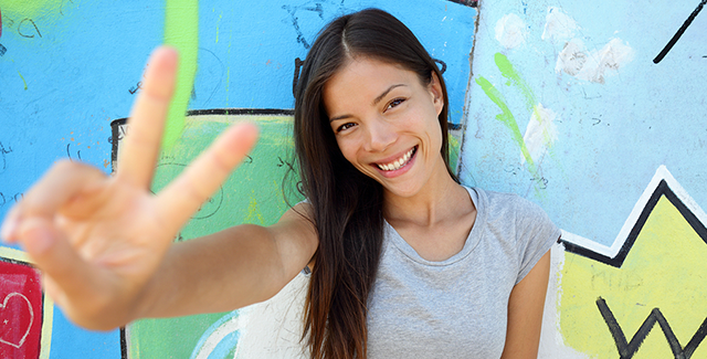 girl giving peace sign